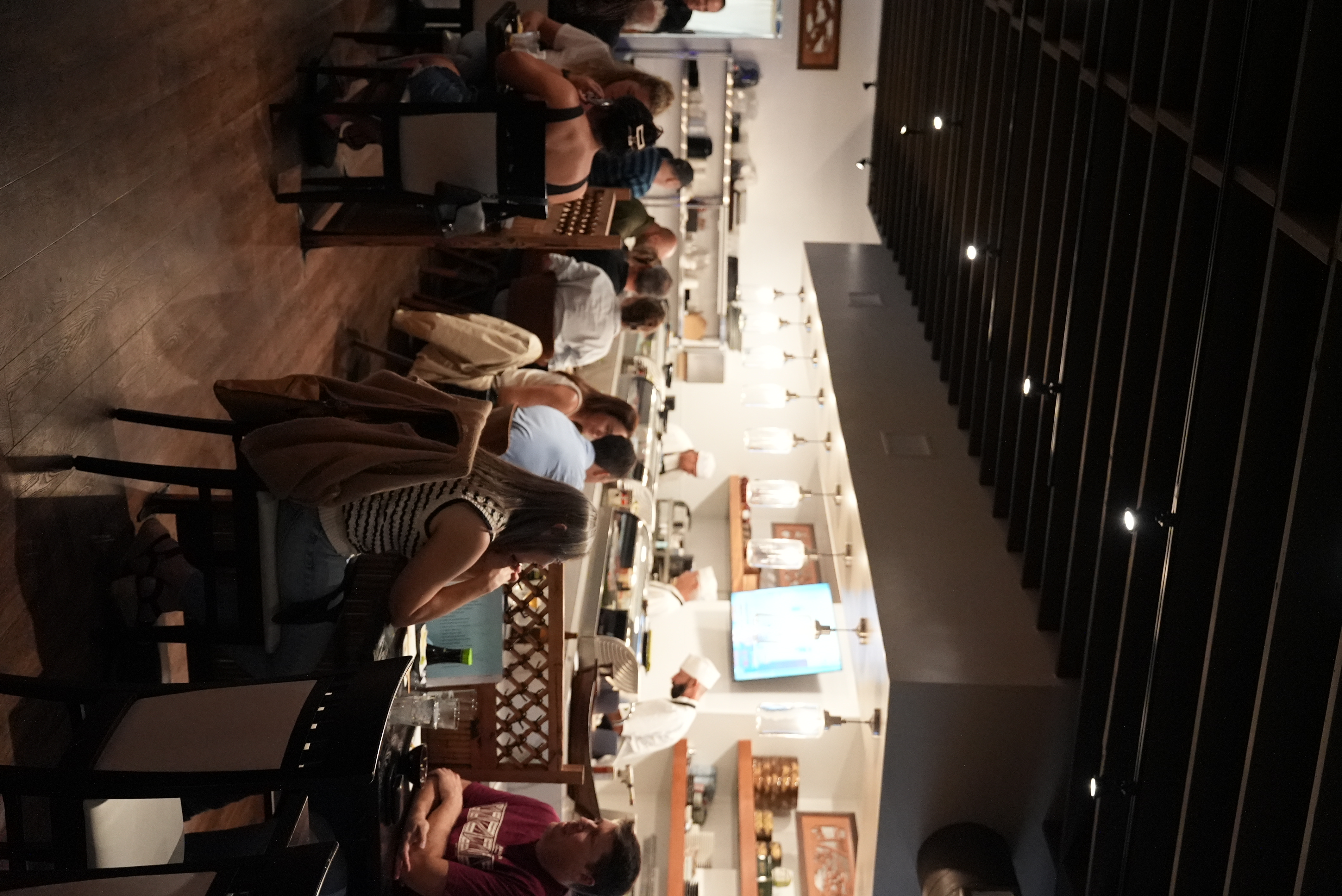 Customers dining beside the working sushi counter at Kihon